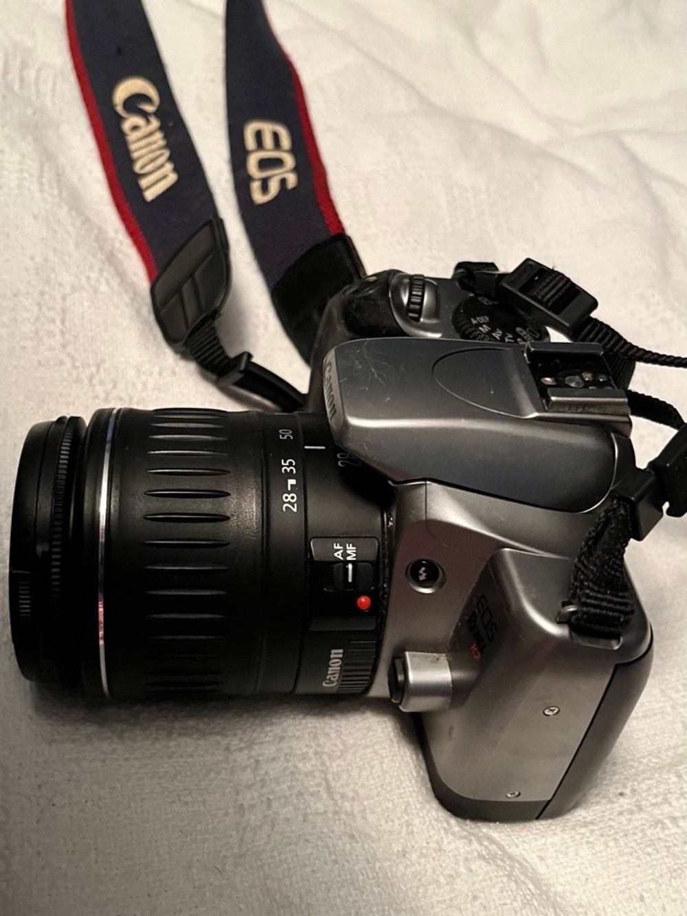 Canon DSLR Camera with Black and Red Branded Strap